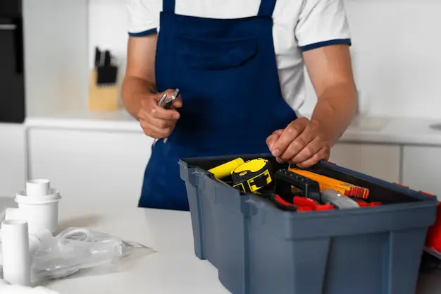 Handyman patching and sanding a hole in a plaster wall